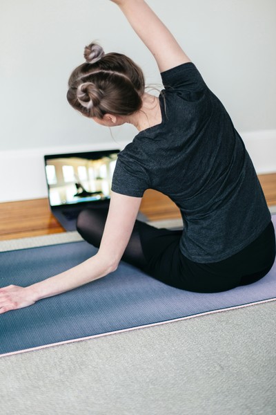 A woman doing an online yoga class in Millarville, AB